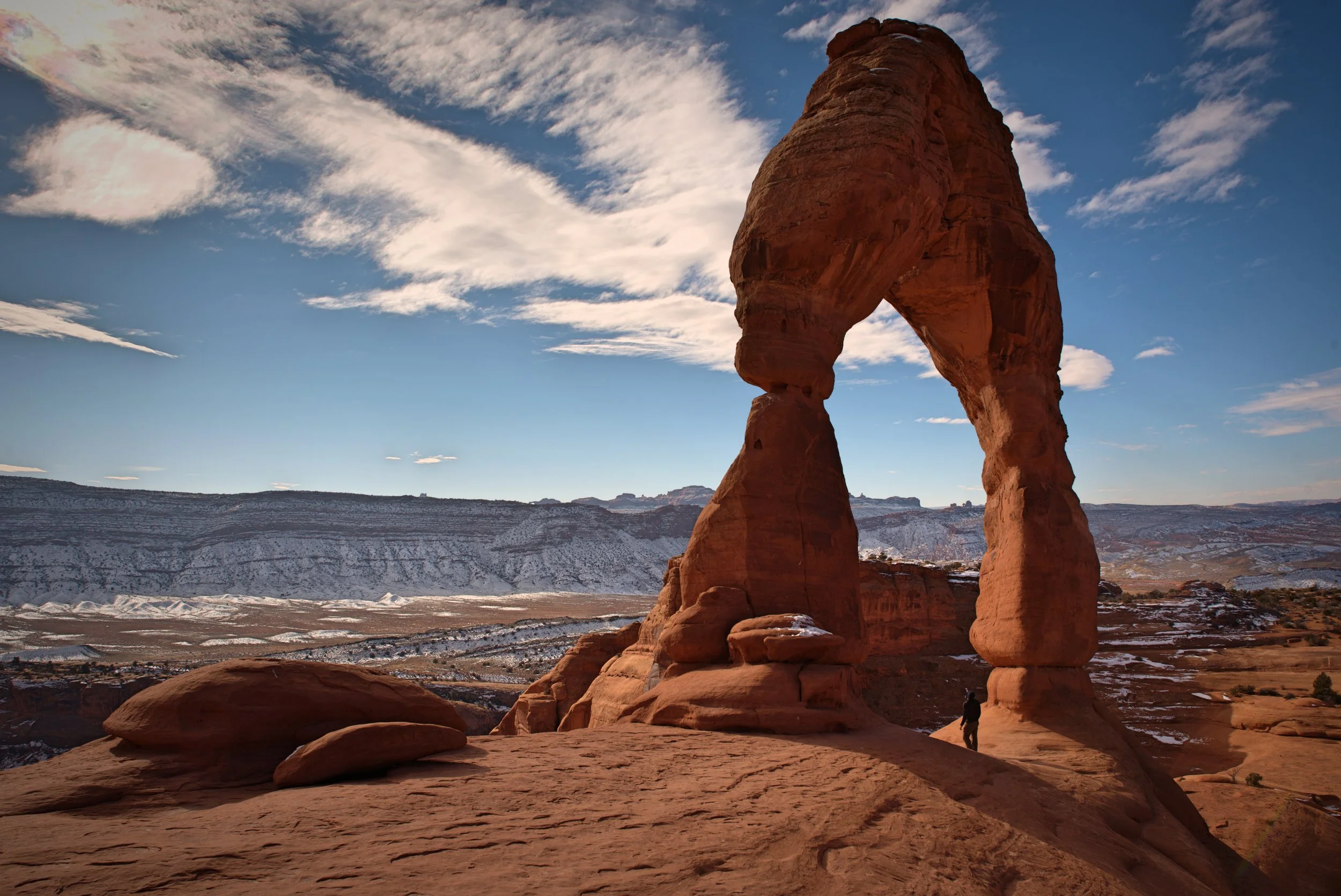 Ian stands below the impressive Delicate Arch.