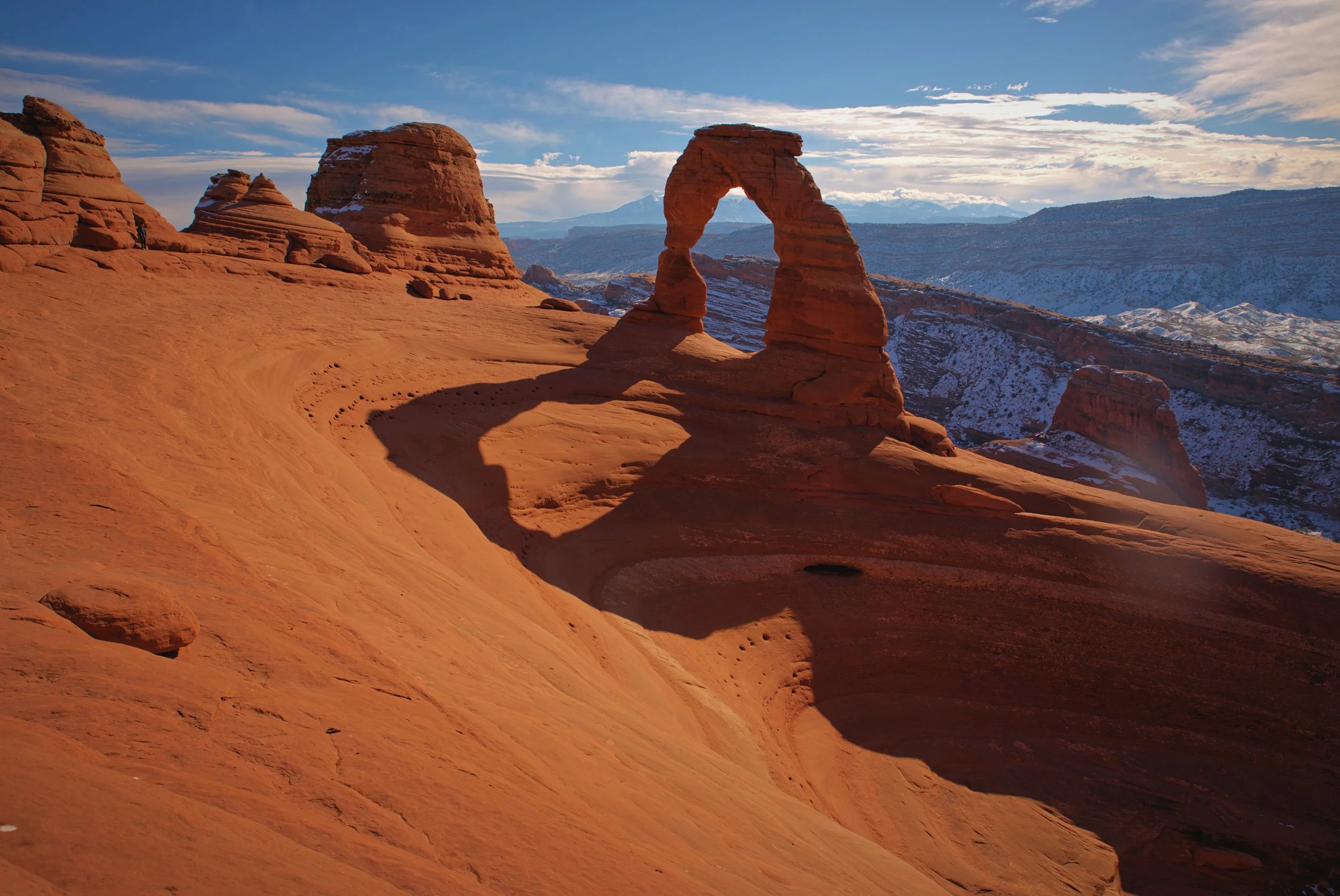 Delicate Arch sits atop an immense and impressive sandstone bowl.