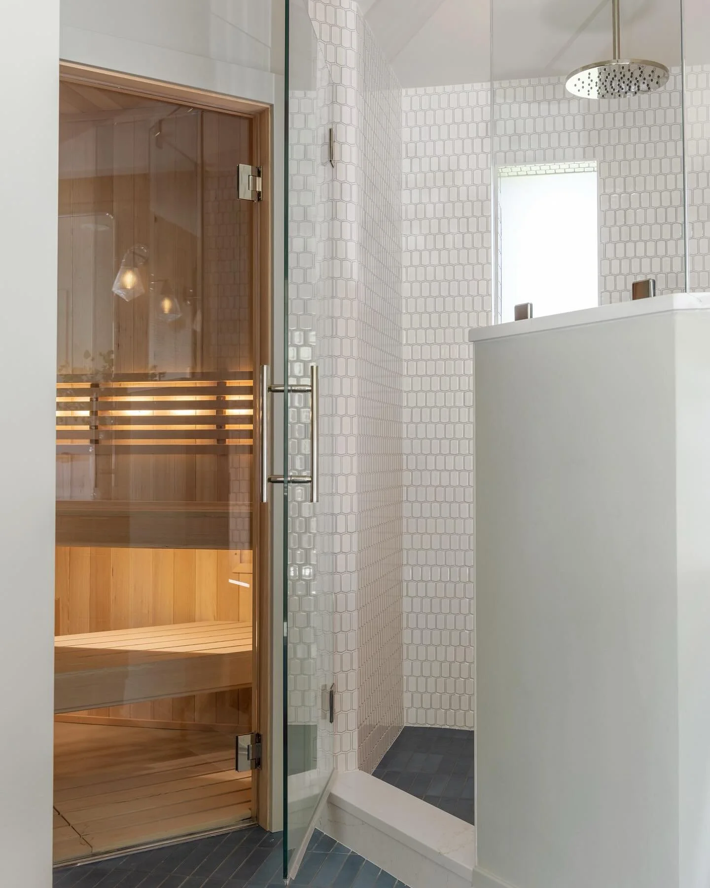 A wellness-forward remodel designed to feel both grounded and elevated🧘&zwj;♀️

The light wood sauna brings warmth and texture, while white dimensional shower tile keeps the space feeling open and bright. Matte blue floor tile adds depth and a subtl