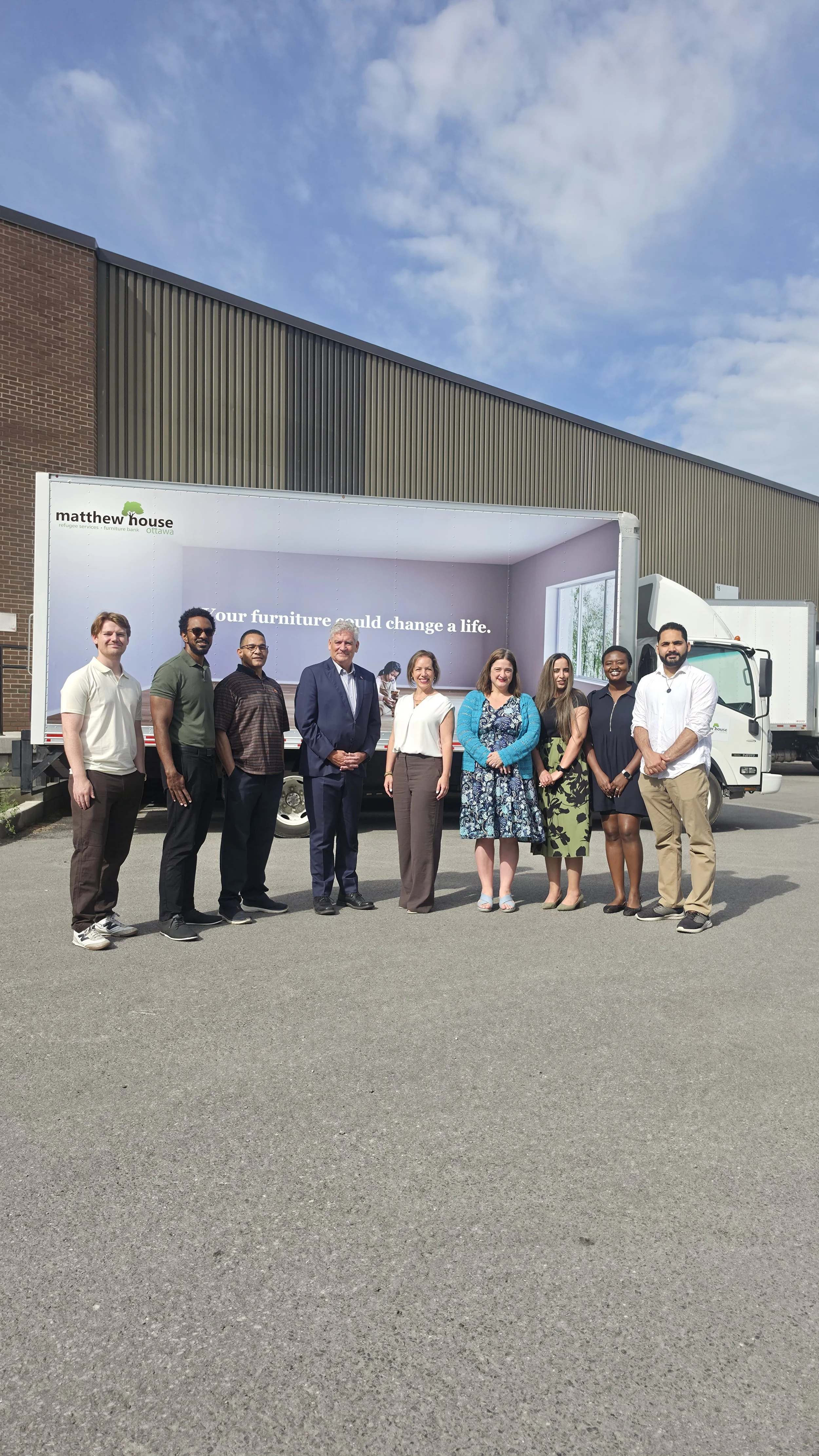Matthew house leadership team members standing in front of a truck