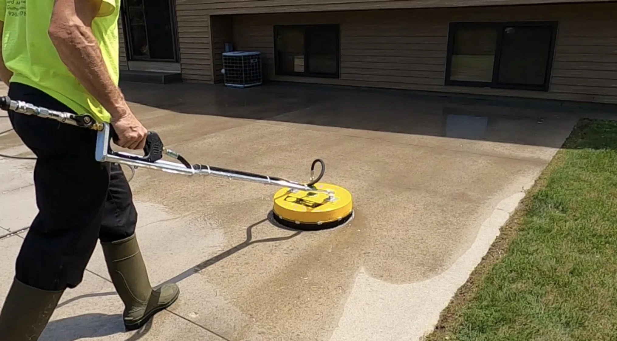 Man using concrete cleaning tool