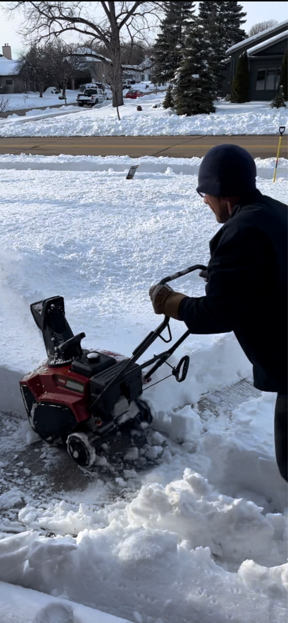 Man snow plowing after winter storm