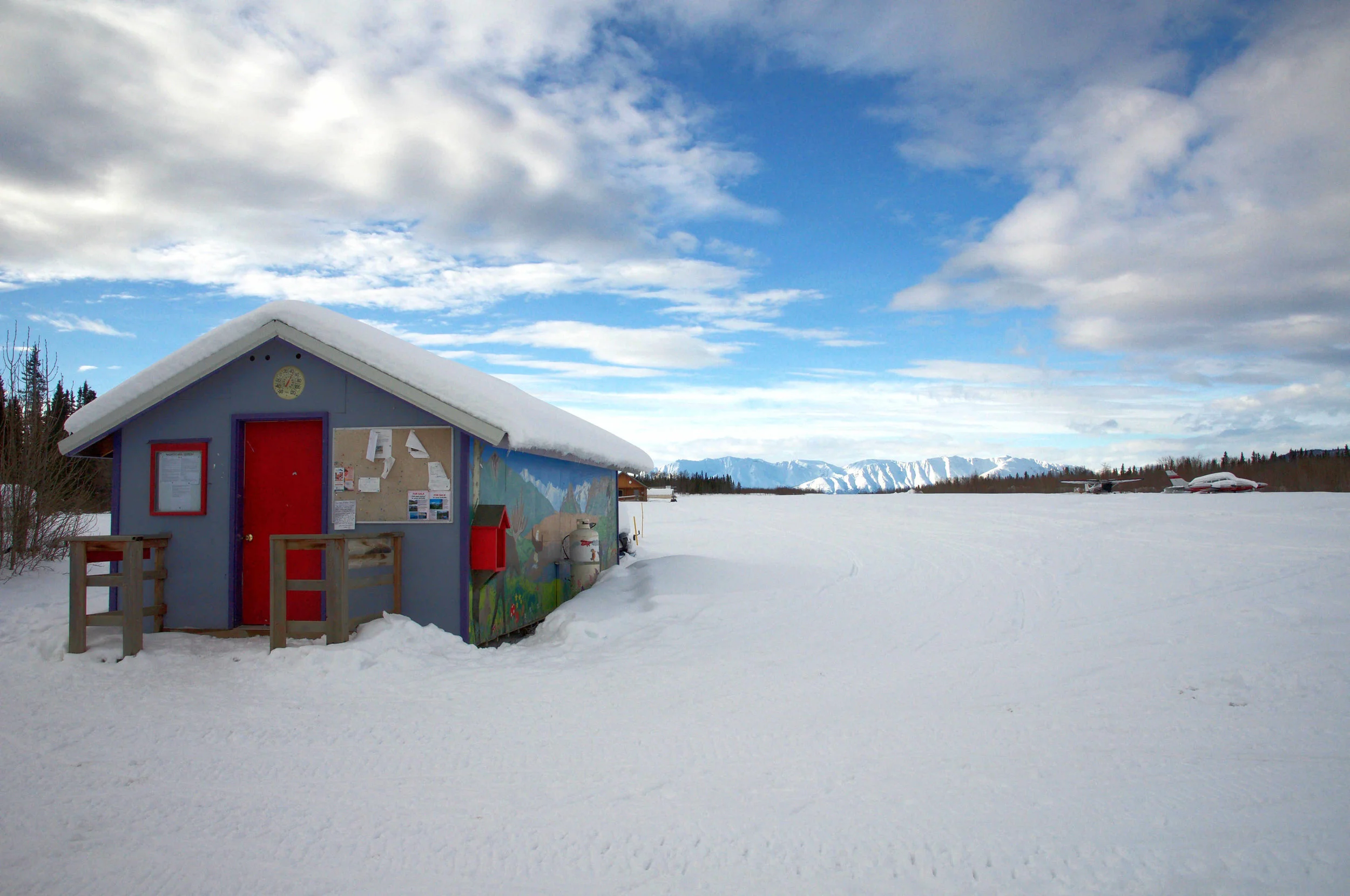 The Chugach Mountains highlighted behind the mail shack.