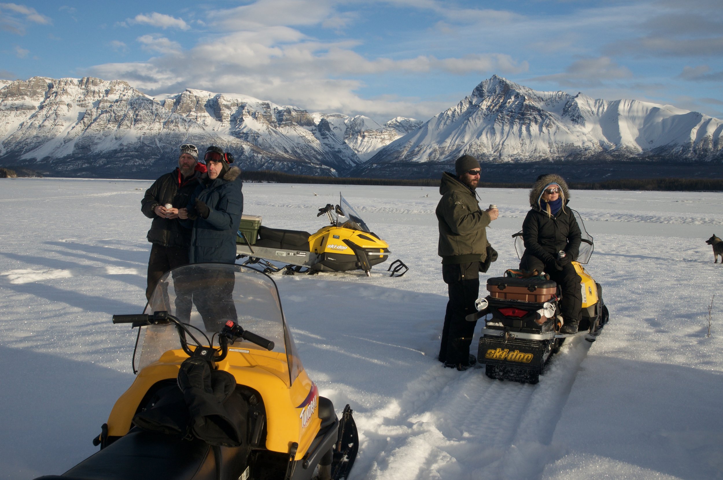  Malcolm Vance, Greg Runyan, Chris Chester and Julia Page stand on the Nizina River after a snow machine ride 