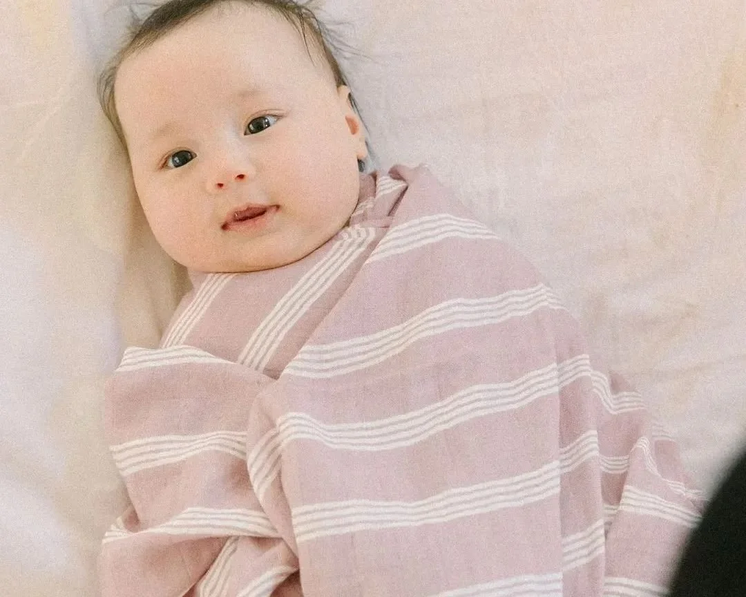 Wrapped in softness, held in love. 🌸

Our Rose Striped Swaddle Blanket is made for the sweetest moments &mdash; the ones where time slows down and it's just Mama and her little one, cozy and close.