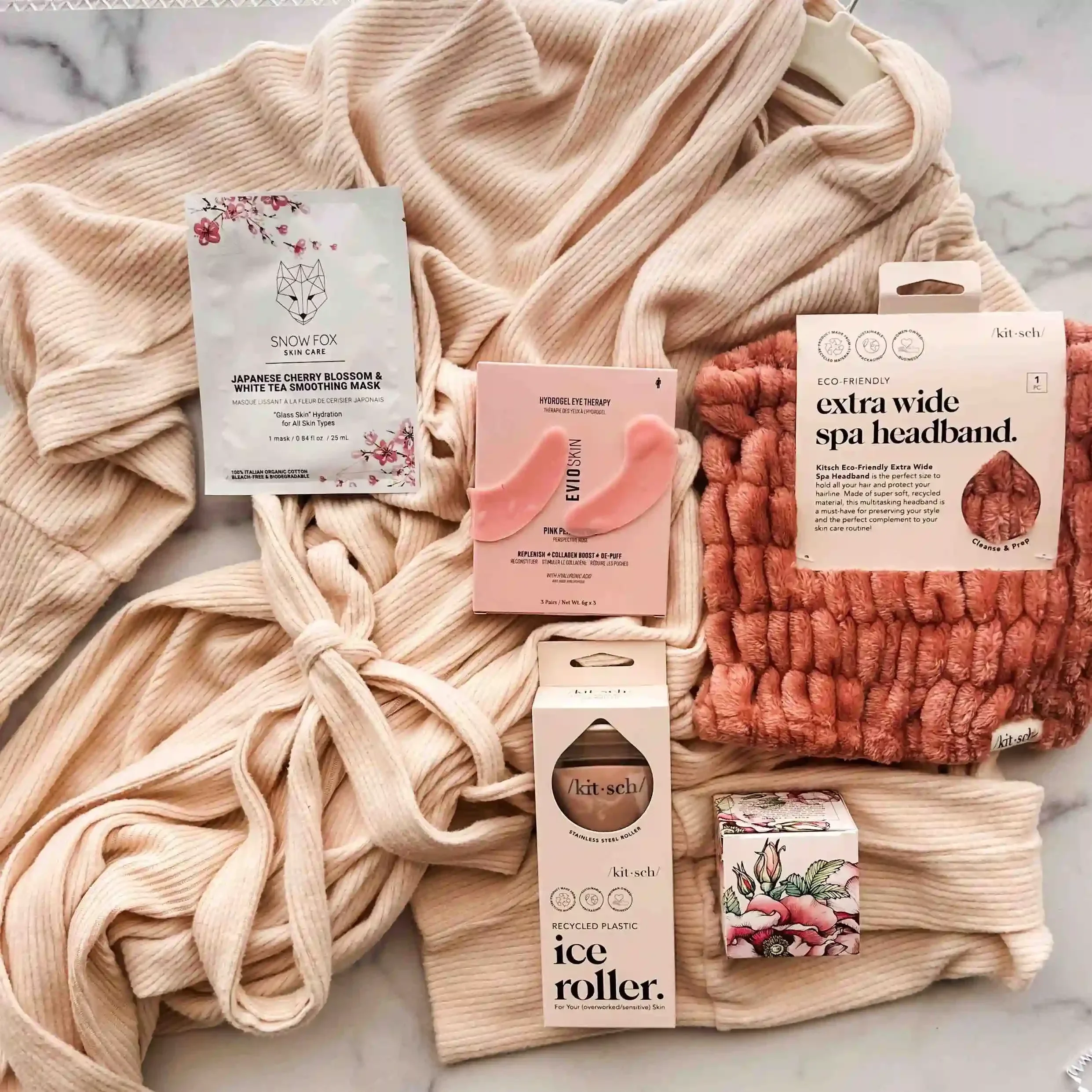 robe, sheet mask, eye patches, ice roller, spa headband, rose lip polish