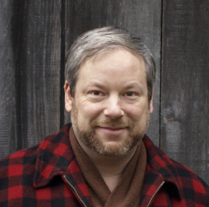 mcevoy headshot plaid new.png