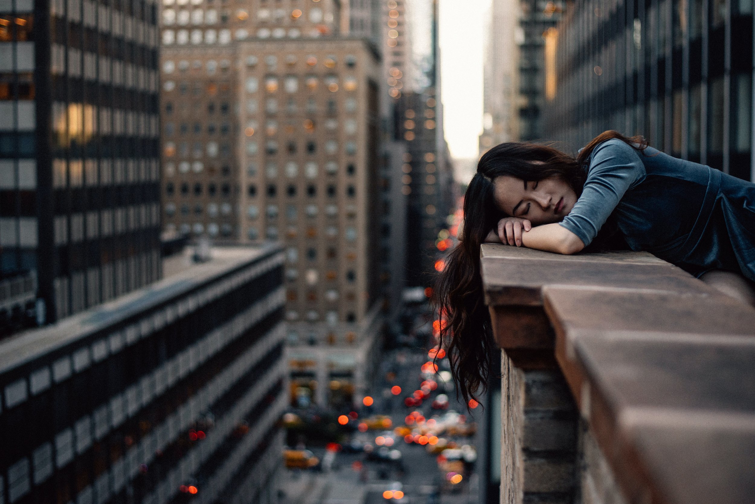 Woman resting on top of building in city