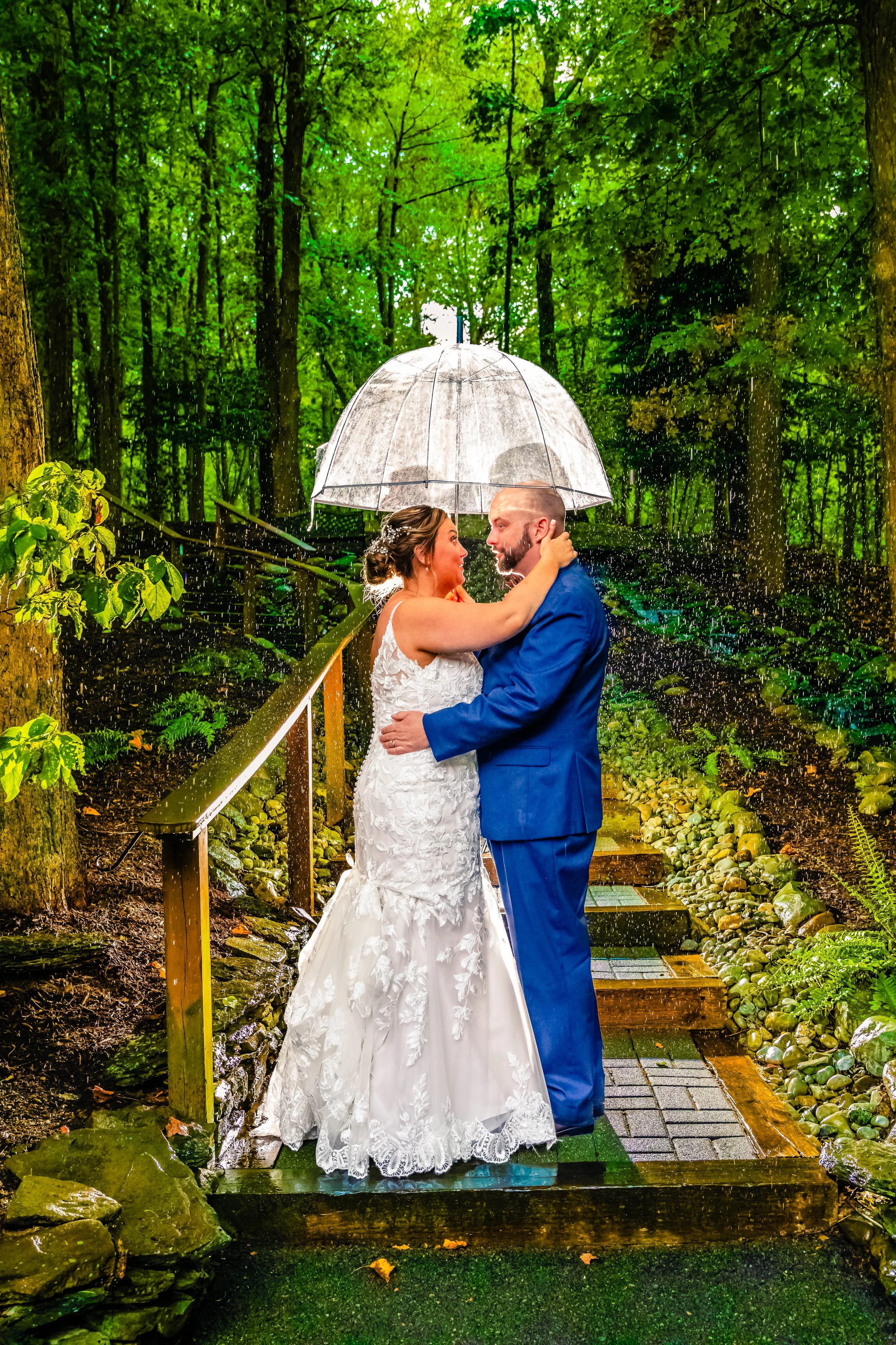young couple kissing under and umbrella in the rain, back light wedding, Stroudsmoor Inn, Stroudsburg, Pennsylvania