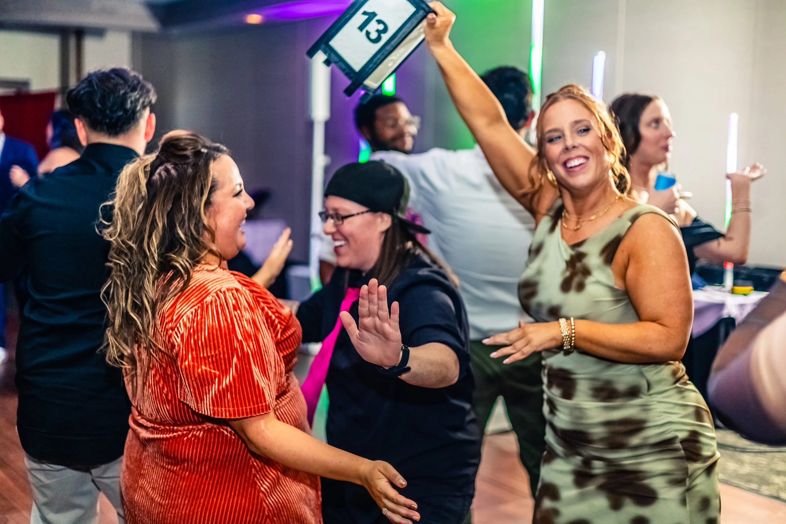 People dancing and celebrating at a party, smiling and enjoying the moment.