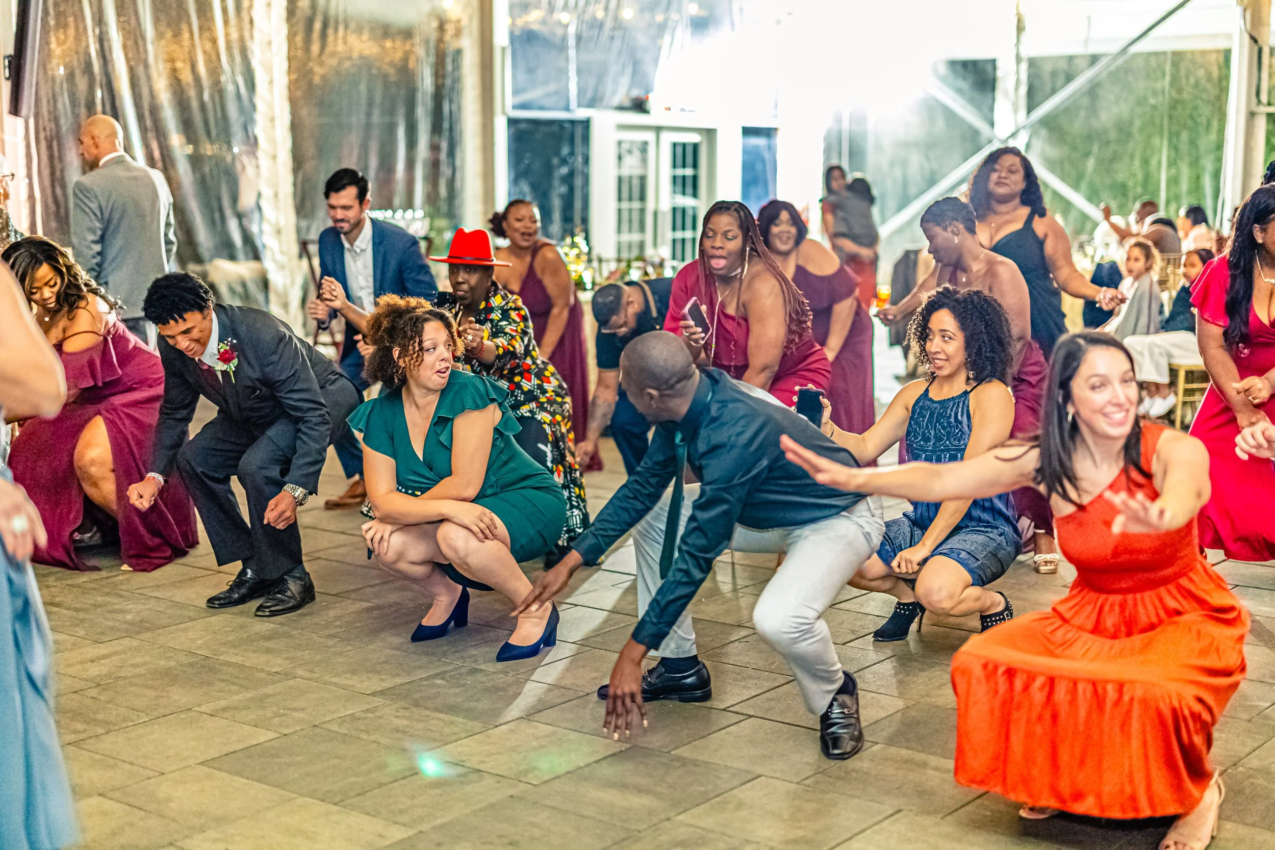 People at a lively celebration or party dancing and having fun indoors.