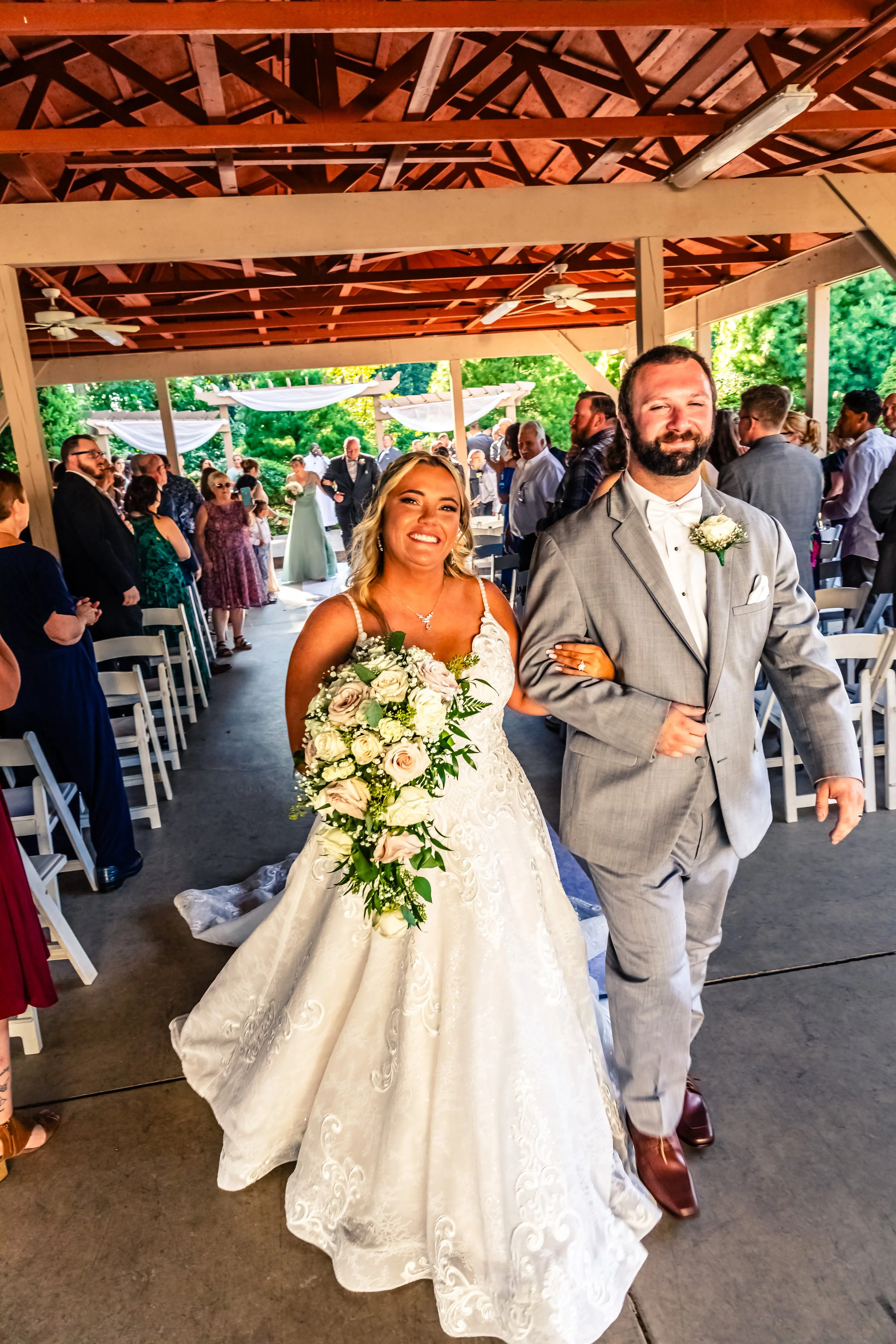 couple walking down the aisle after wedding vows, wedding guests in the background, Sand Springs, Drums, Pennsylvania