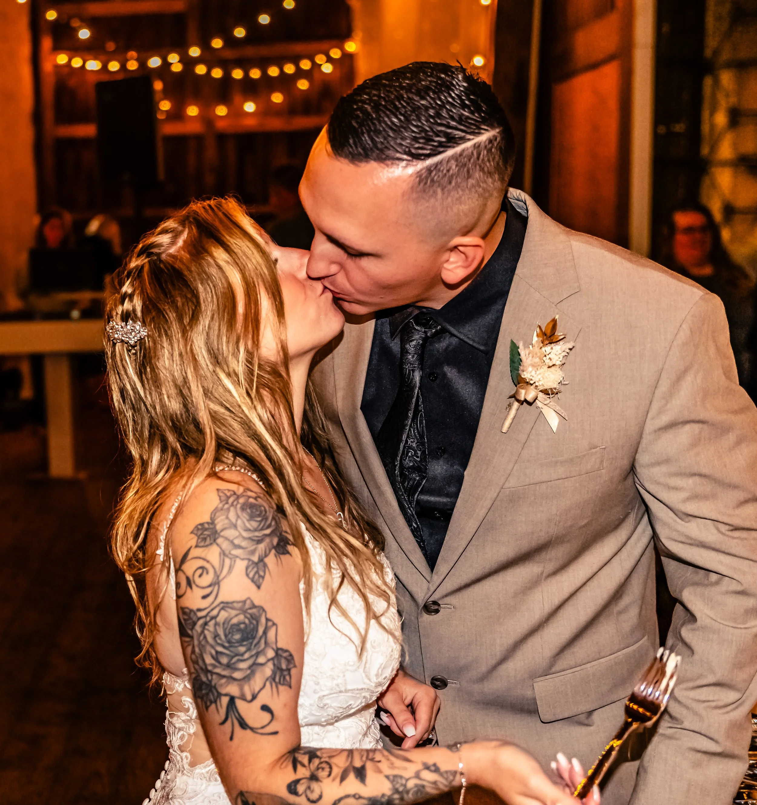 young couple groom kissing bride, wedding, night shot in a barn, Ludlow Farm Perkasie Pennsylvania