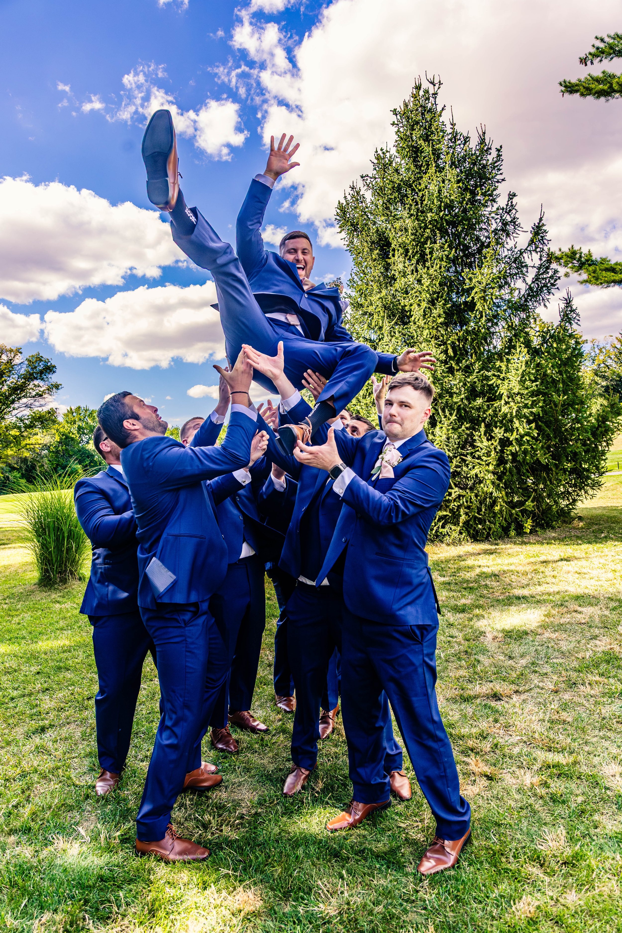 groomsman tossing groom in the air, wedding, green pond, Pennsylvania