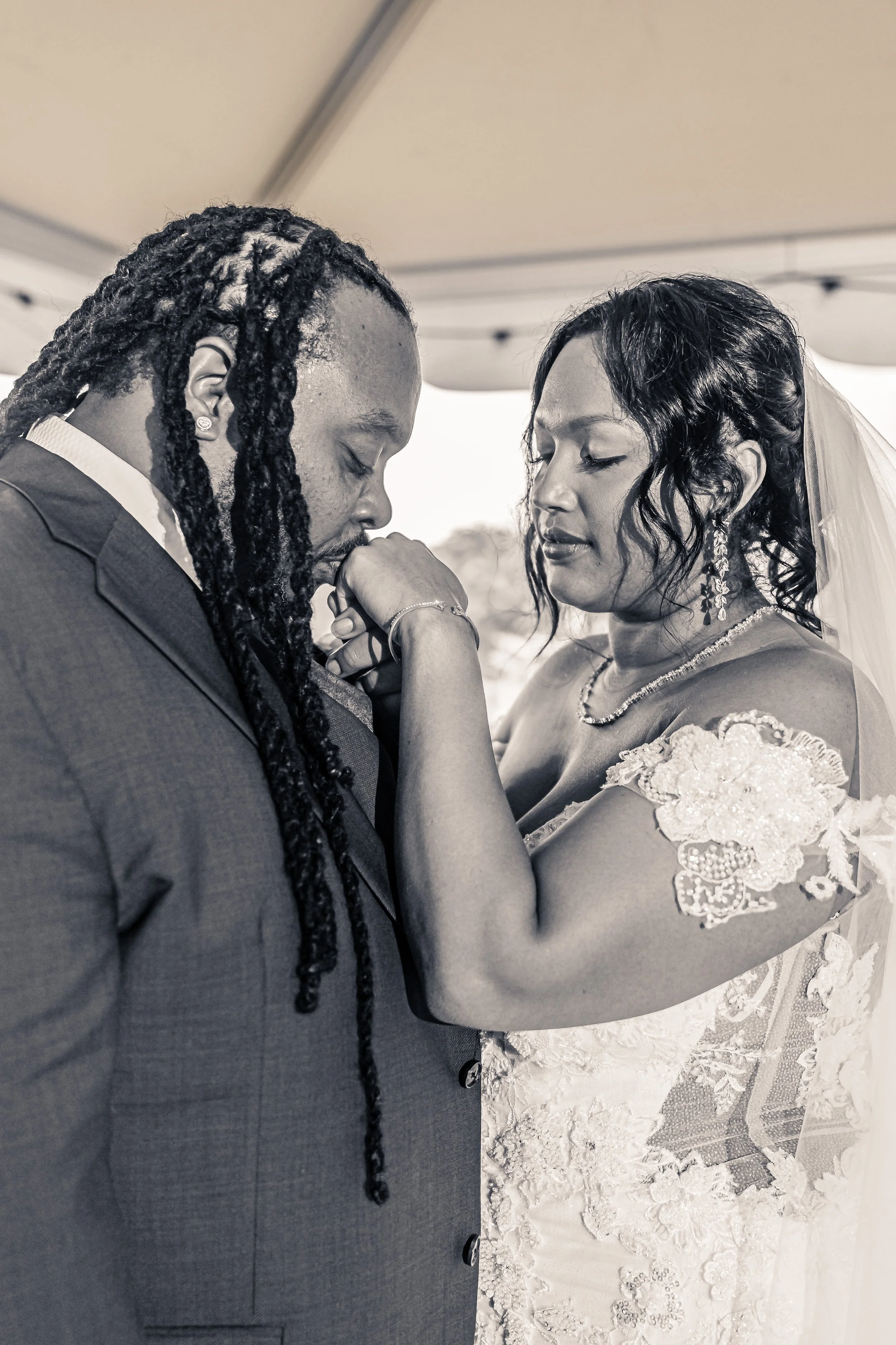 couple posing after first look groom kissing brides hand, black and white photo, wedding, Blue Mountain Lodge, Palmerton, Pennsylvania