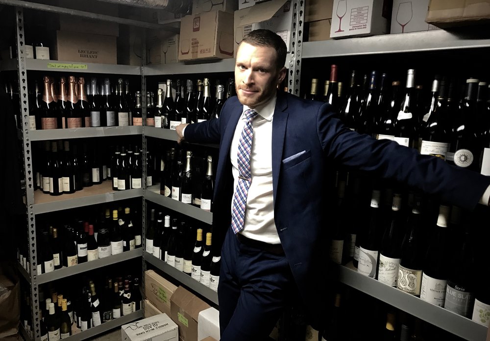 Smith shows off the selection in Sushi Nakazawa's wine cellar.