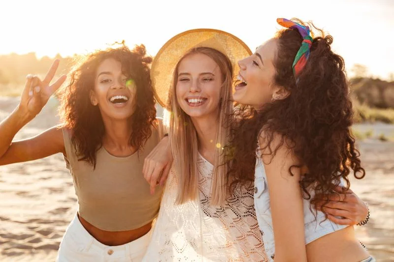 Image of three joyous multiethnic girls 20s in stylish clothing laughing and___.jpg