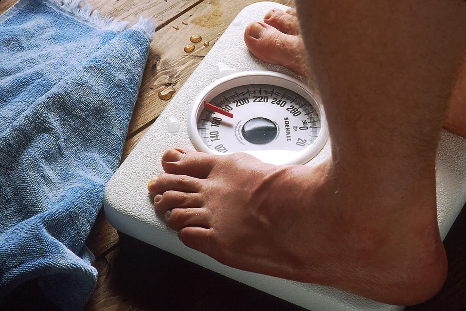 17079-close-up-of-feet-standing-on-a-scale-pv.jpg