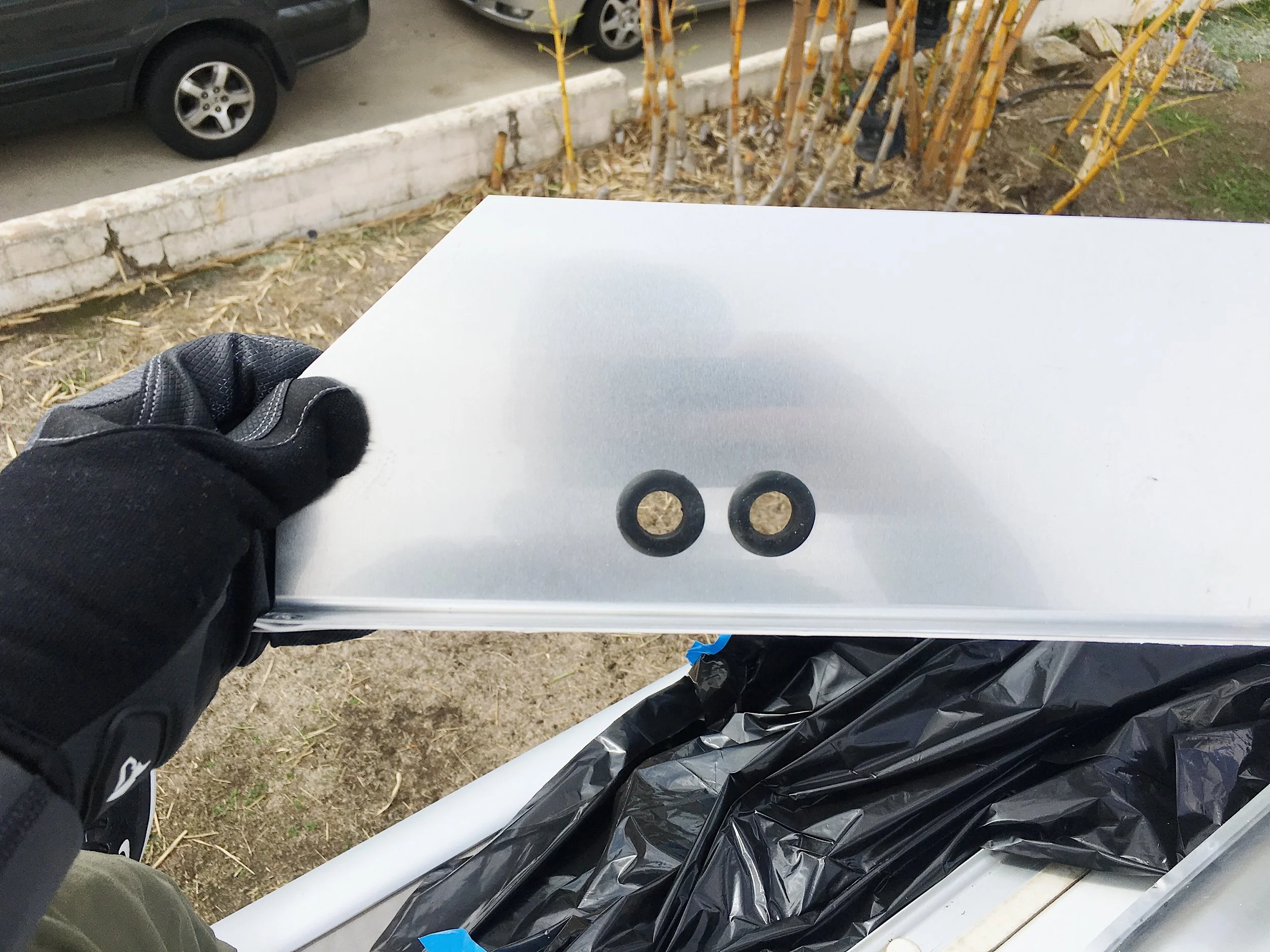 Drilled 2 holes and added grommets to prevent the wire from rubbing against the metal.