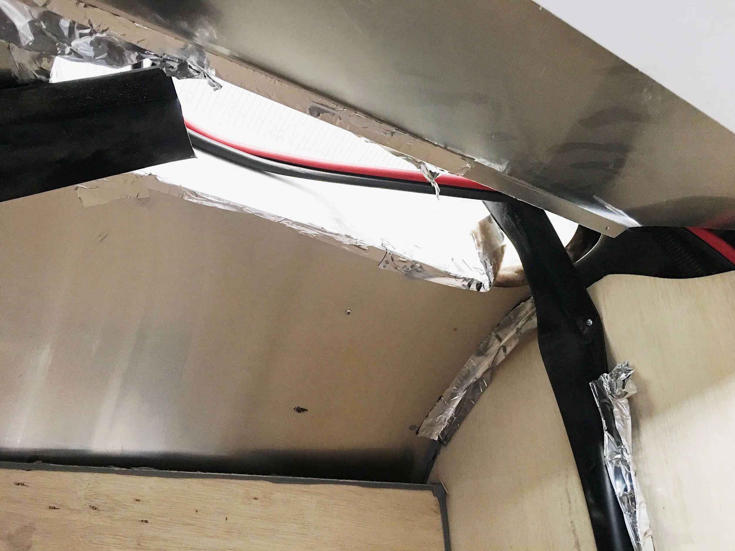 Wire running across to the space between the fridge and the wall holding the TV.