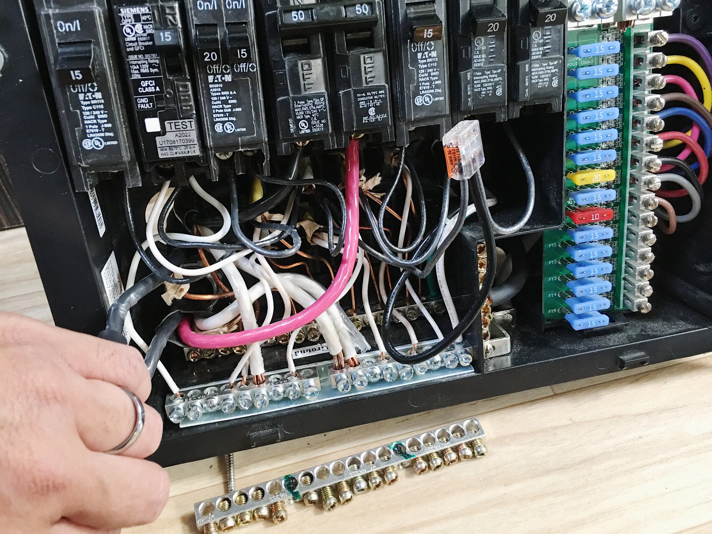 The original bus bar on the floor and the 2 separate bus bars immediately above it in the box.