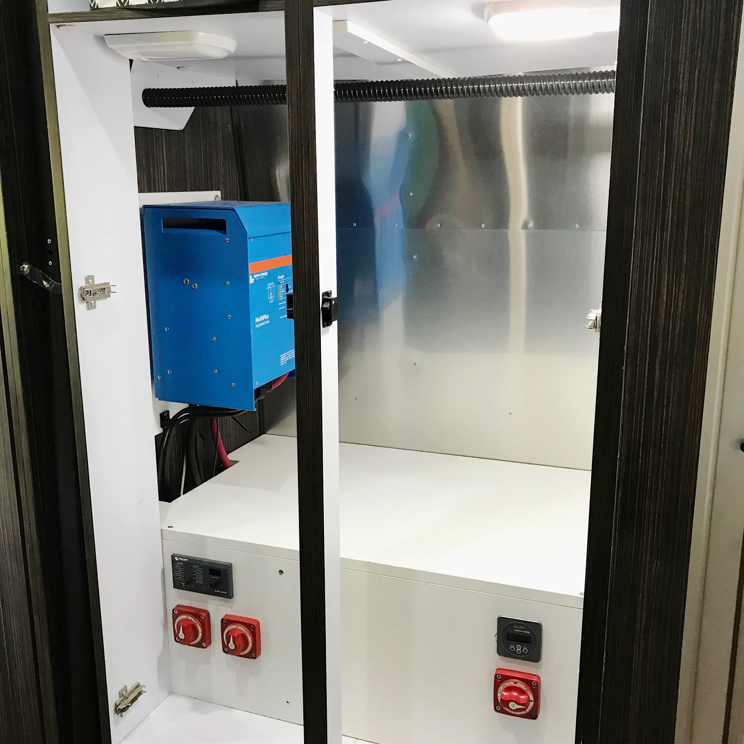 Finished box with cut-off switches, inverter control pane, and battery monitor.