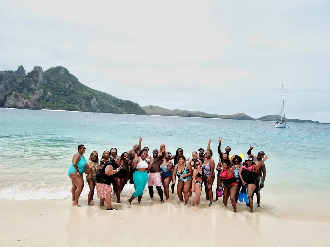 Kenna (far left) and a few travel friends enjoying the white sands of Fiji.