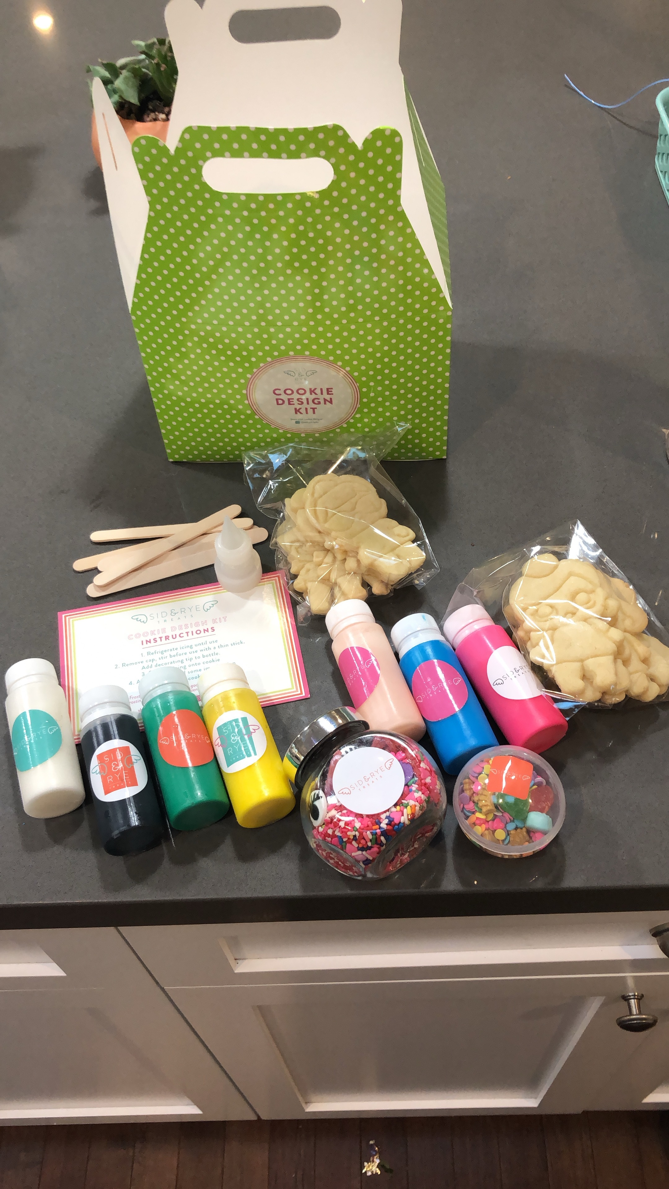 Sample box. Colors and sprinkles vary Box includes 4 bottles icing. For this box, extra bottles of frosting were ordered.
