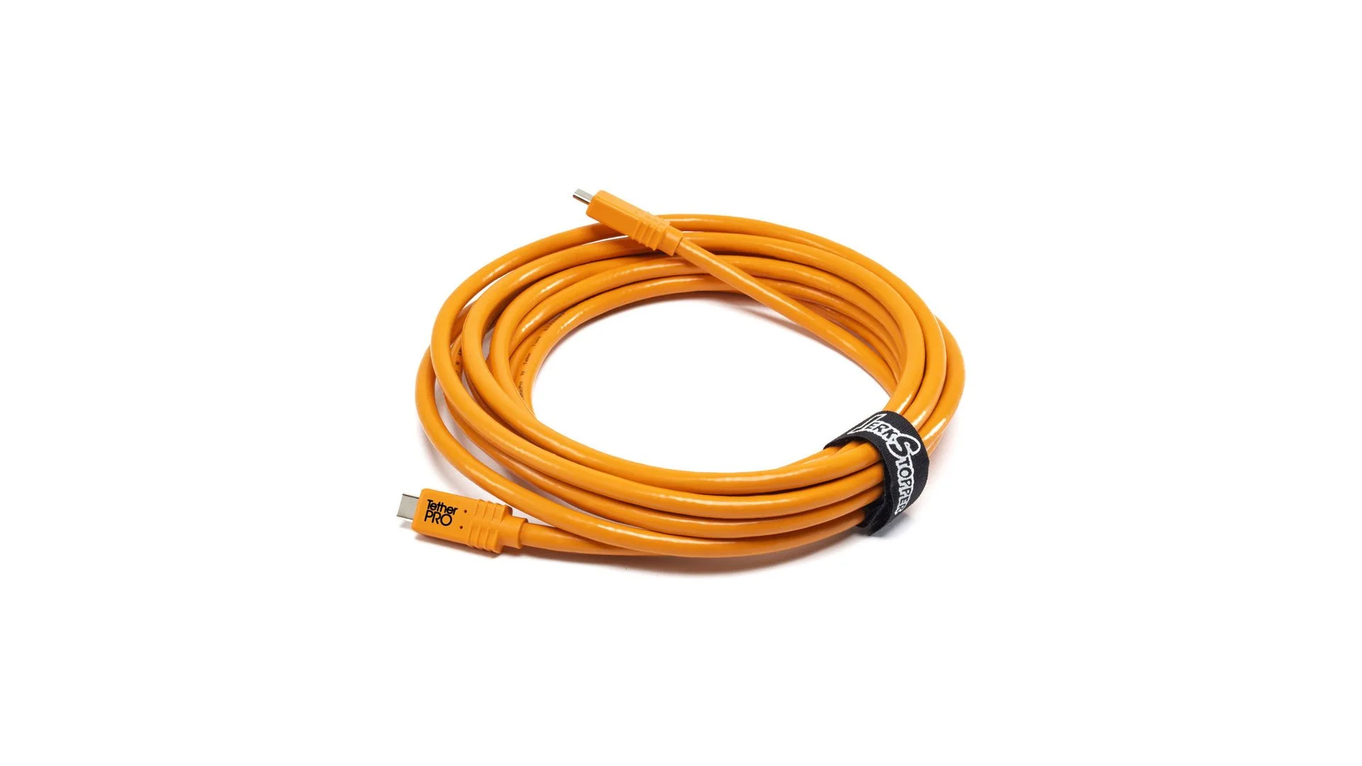 Orange electrical extension cord coiled with a black Velcro strap