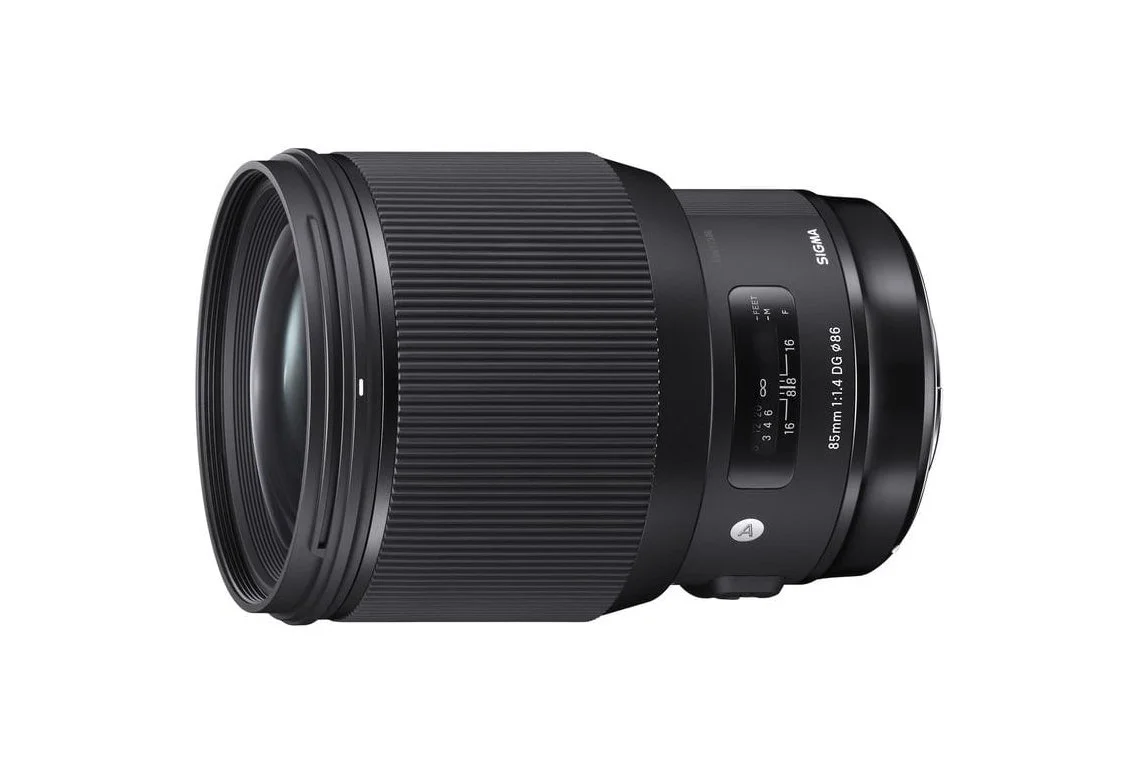 A black Sigma 85mm camera lens with focus and zoom rings, and aperture markings, designed for professional photography.
