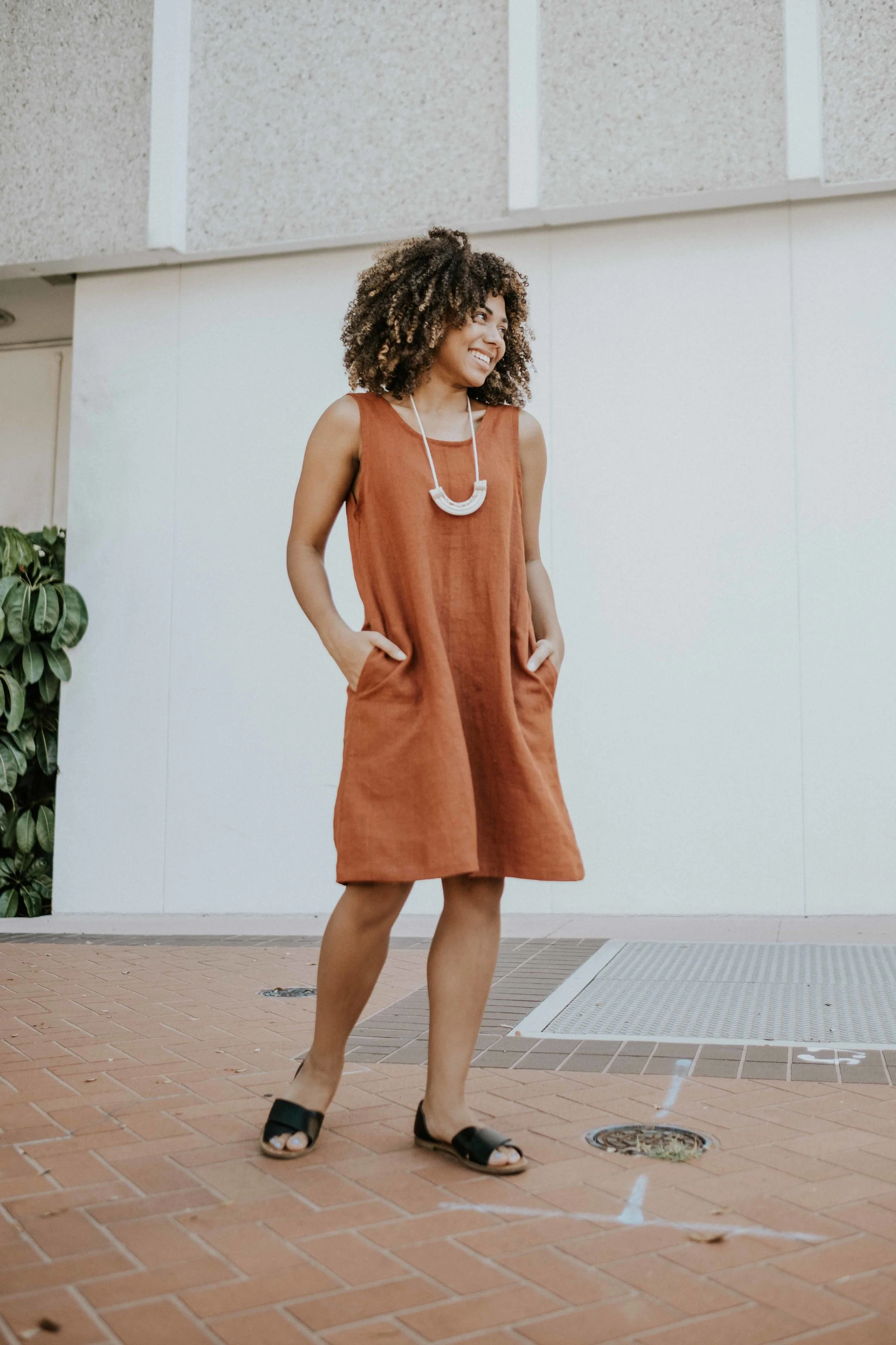 Solie modeling the Elinor Dress Scoop Back Dress featured in rust linen