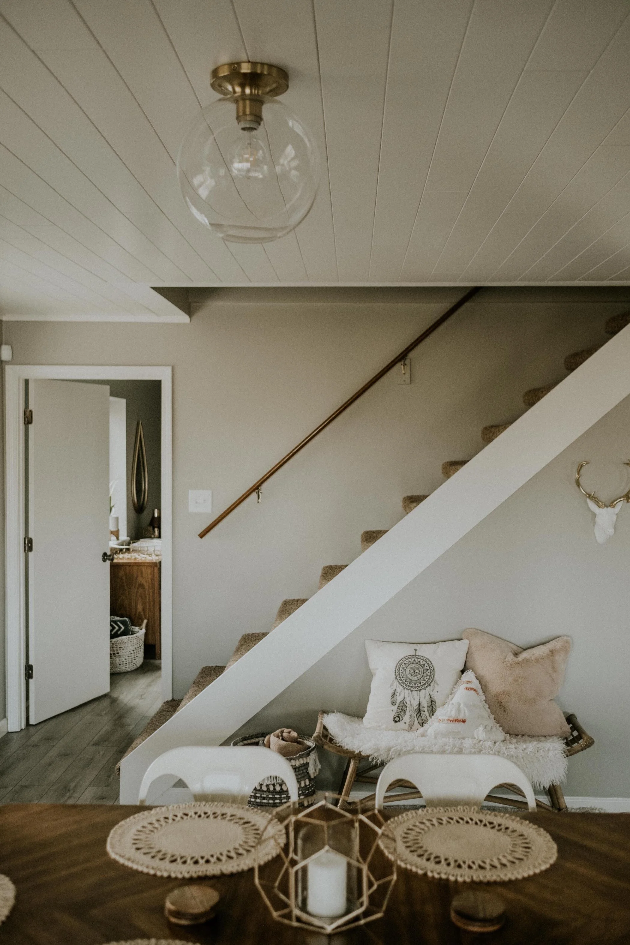 The downstairs floor was another stunning home of it’s own - with a beautiful and cozy living room, record player corner, dining area, master bed + bath, and a laundry room!
