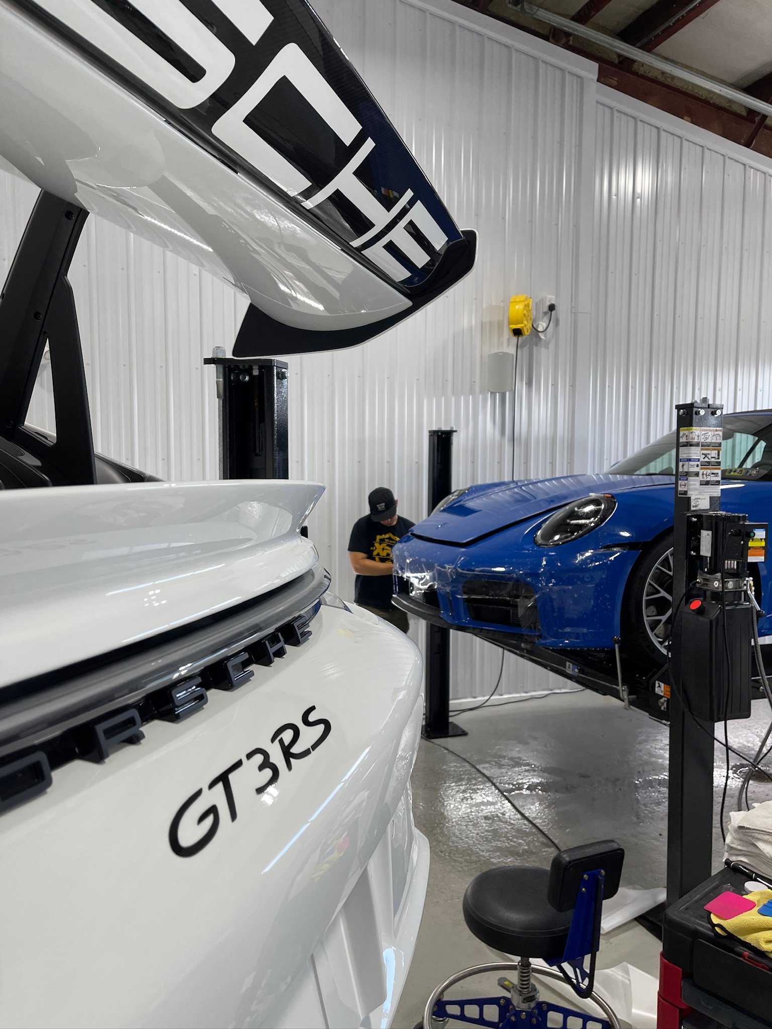 two porsches on lifts