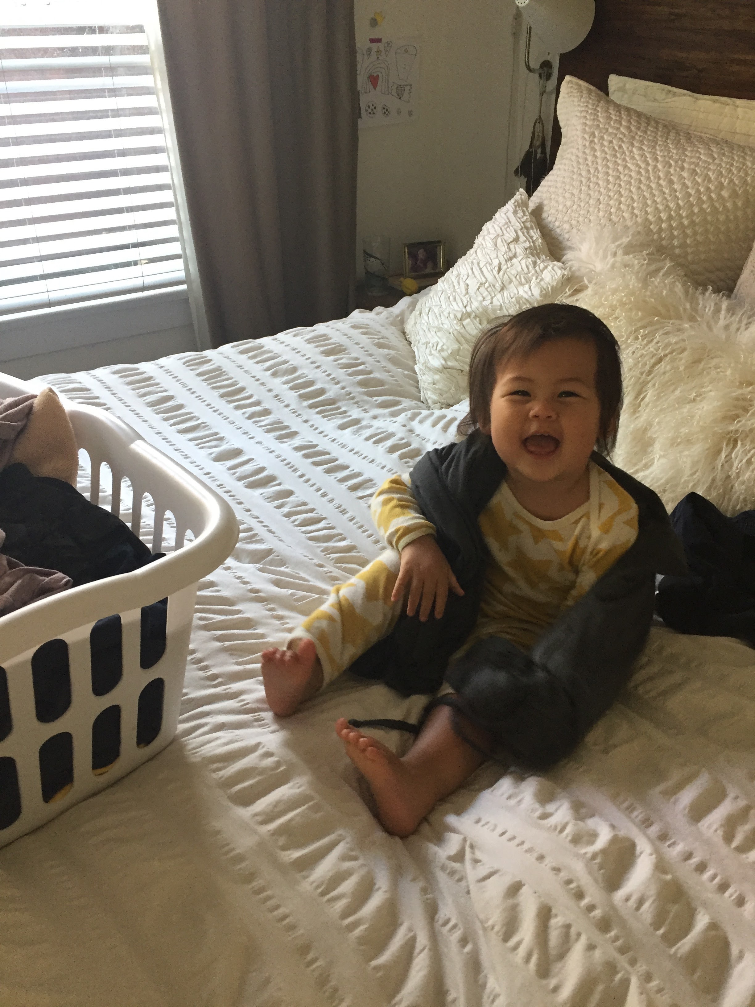 gleefully dismantling newly-folded laundry