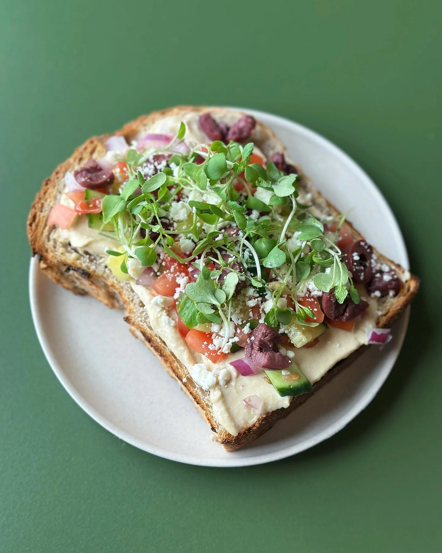 The Mediterranean Toast - we could eat this for breakfast, lunch and dinner. Hummus, feta, Kalamata olives, red onion, cucumber, tomato, finished off with some fresh lemon + micro greens on our organic sour dough ✨ the ultimate summer snack - open 8a