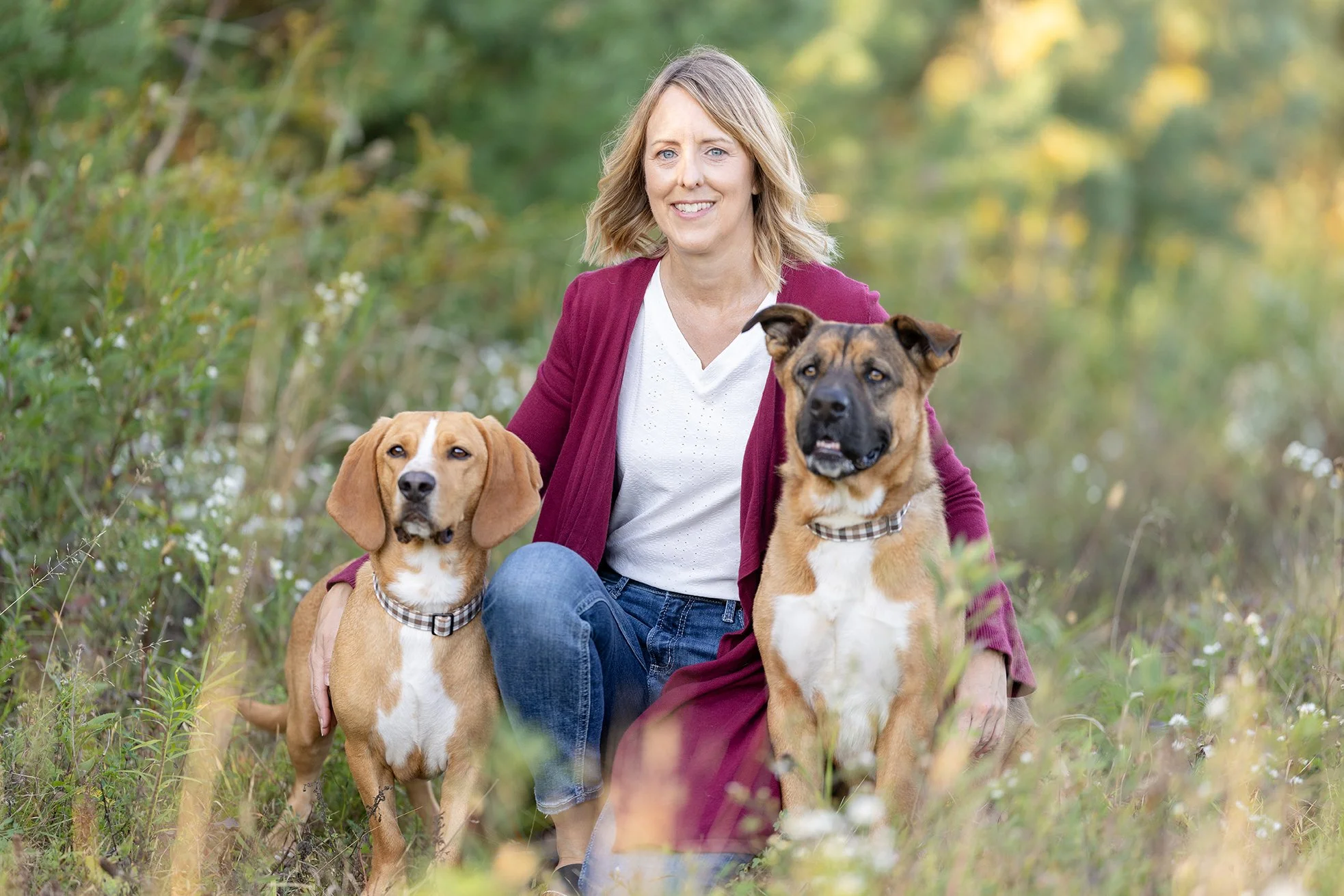Two dogs and their owner pose for their photography session in WIsconsin
