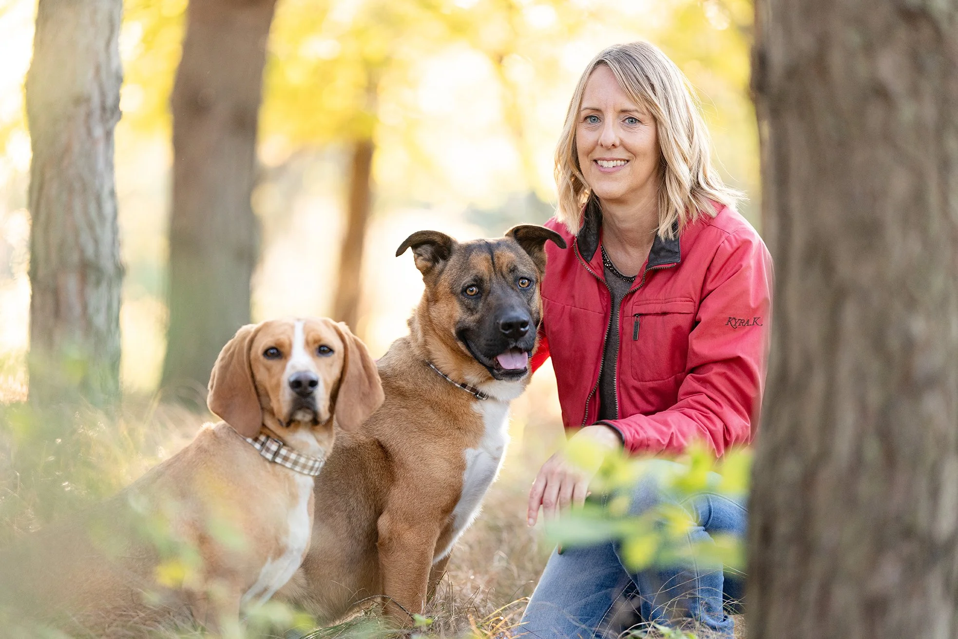Two dogs pose with their owner for a fall wisconsin portait session