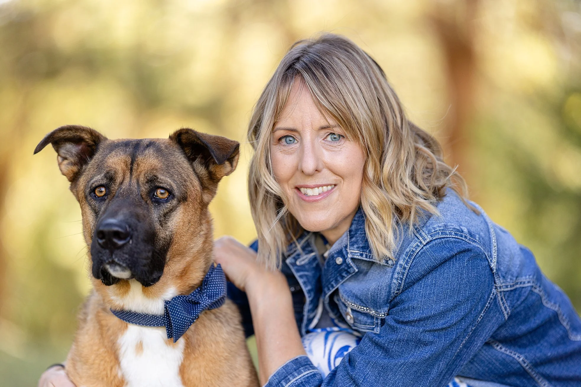 Dog, Ariat, and his owner, Ann, posing for a photo