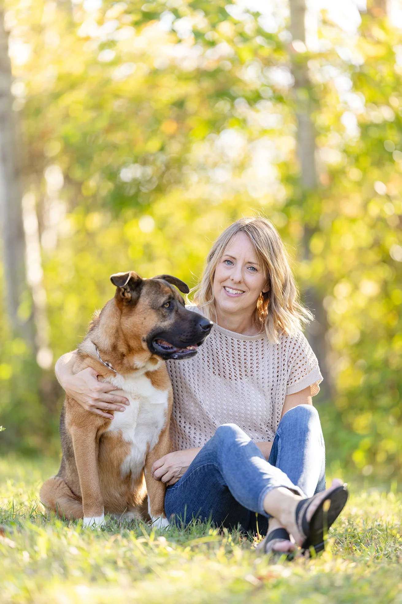 Dog and owner sit posing for a portrait