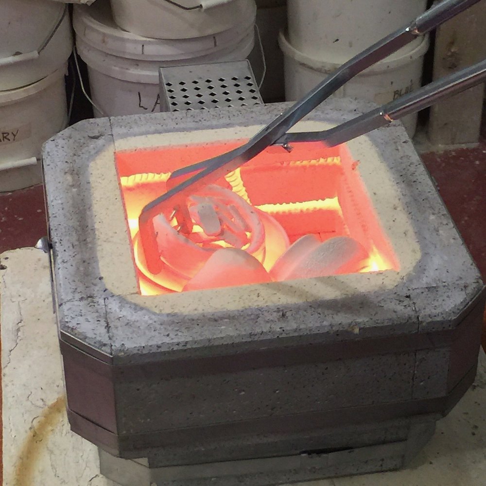   Pulling pieces from hot kiln  