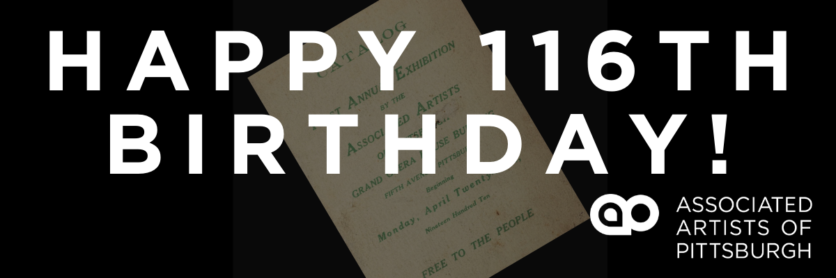 Photograph of a exhibition catalog from 1910 that is white with green text. On top of the photo is text that says happy 116th birthday! and the associated artists of pittsburgh logo and branding.