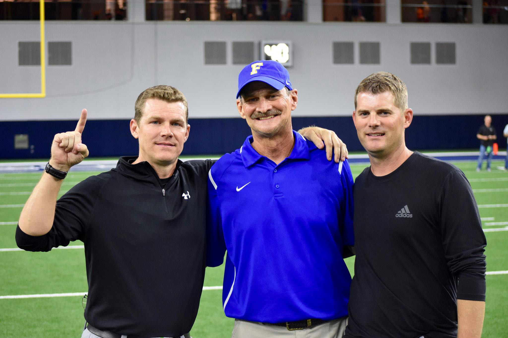 ^ Josh with his father, Vance, and brother, Justin, during a game against Frisco at the Dallas Cowboys’ Star Stadium. Josh was coached by his father, and has coached with both his father and his brother.