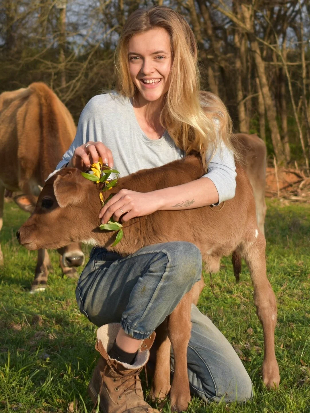 Annemarie checks on a new baby from one of her Jersey cows, known for their delicious milk (used for her personal use).