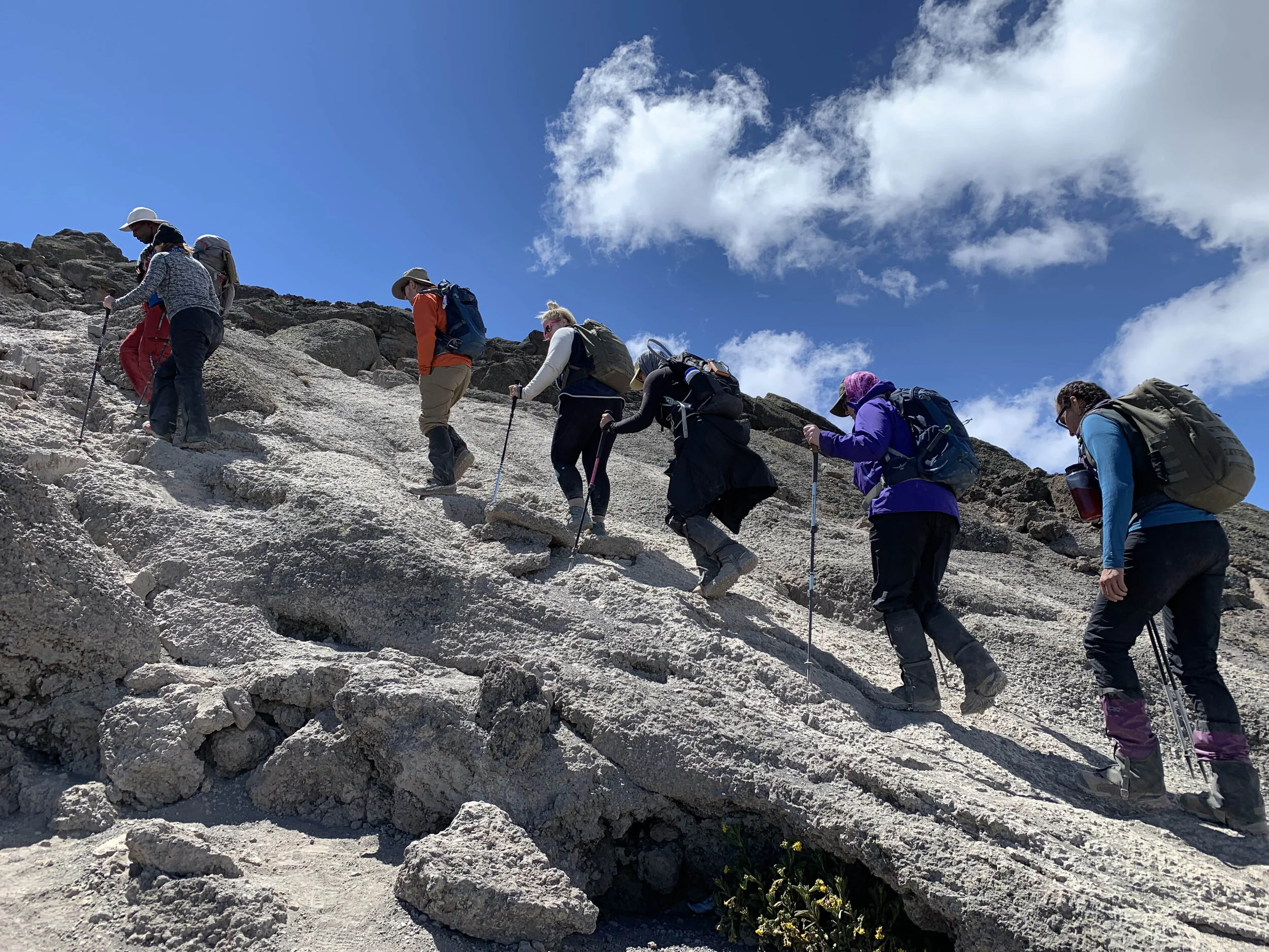 At 16,000 feet elevation, Deirdre Smith, Dr. Malcolm Smith, Ann Mancheski, Dr. Jennifer Thompson, Cheryl Kite and Melinda Krueger hike with their guide from Barafu Camp to Kosovo Camp, the day before summit day.