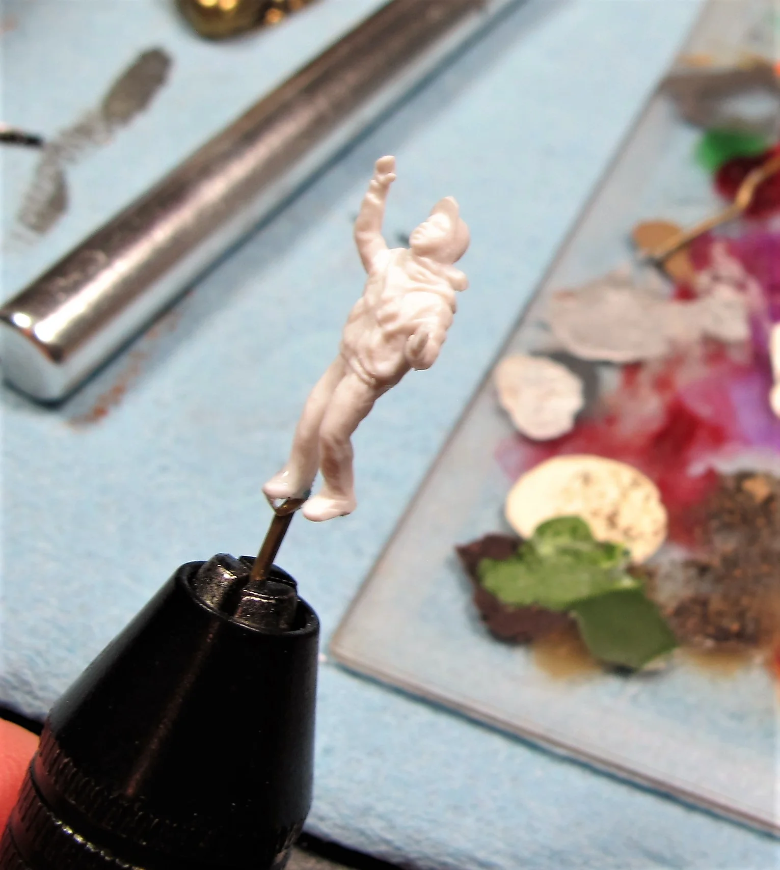 Add a cyanoacrylate glue to the hole and cement the pin into the foot hole. Be extra careful, this plastic is delicate.