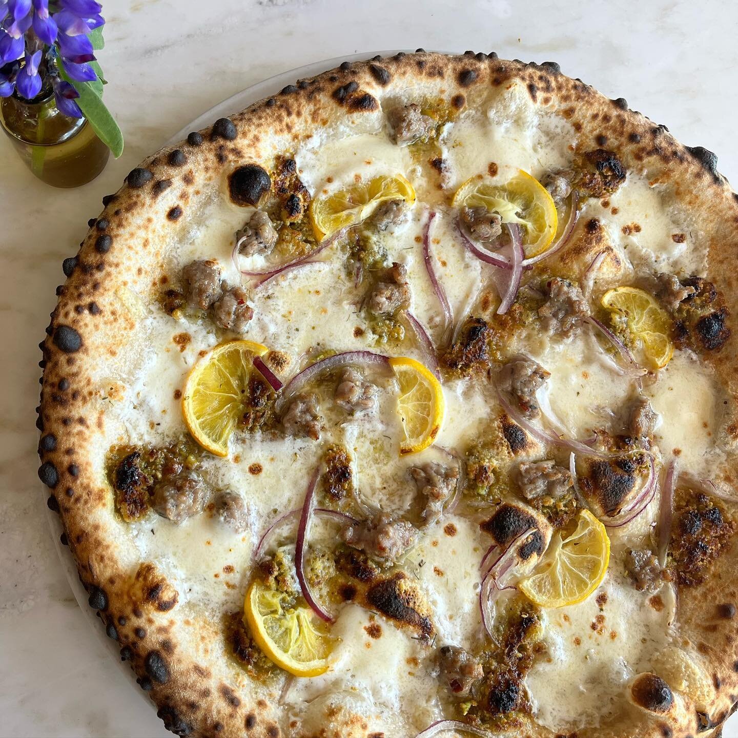 Gorgeous Meyer Lemon pizza is officially back on the menu with @rincontropics meyers, @casitasvalleypastures house sausage, red onion and pistachio paste. See you at 11:30am! 👨&zwj;🍳 @vicariouslyjosh @ed.uard.oo @sadisticshark @despera.sean