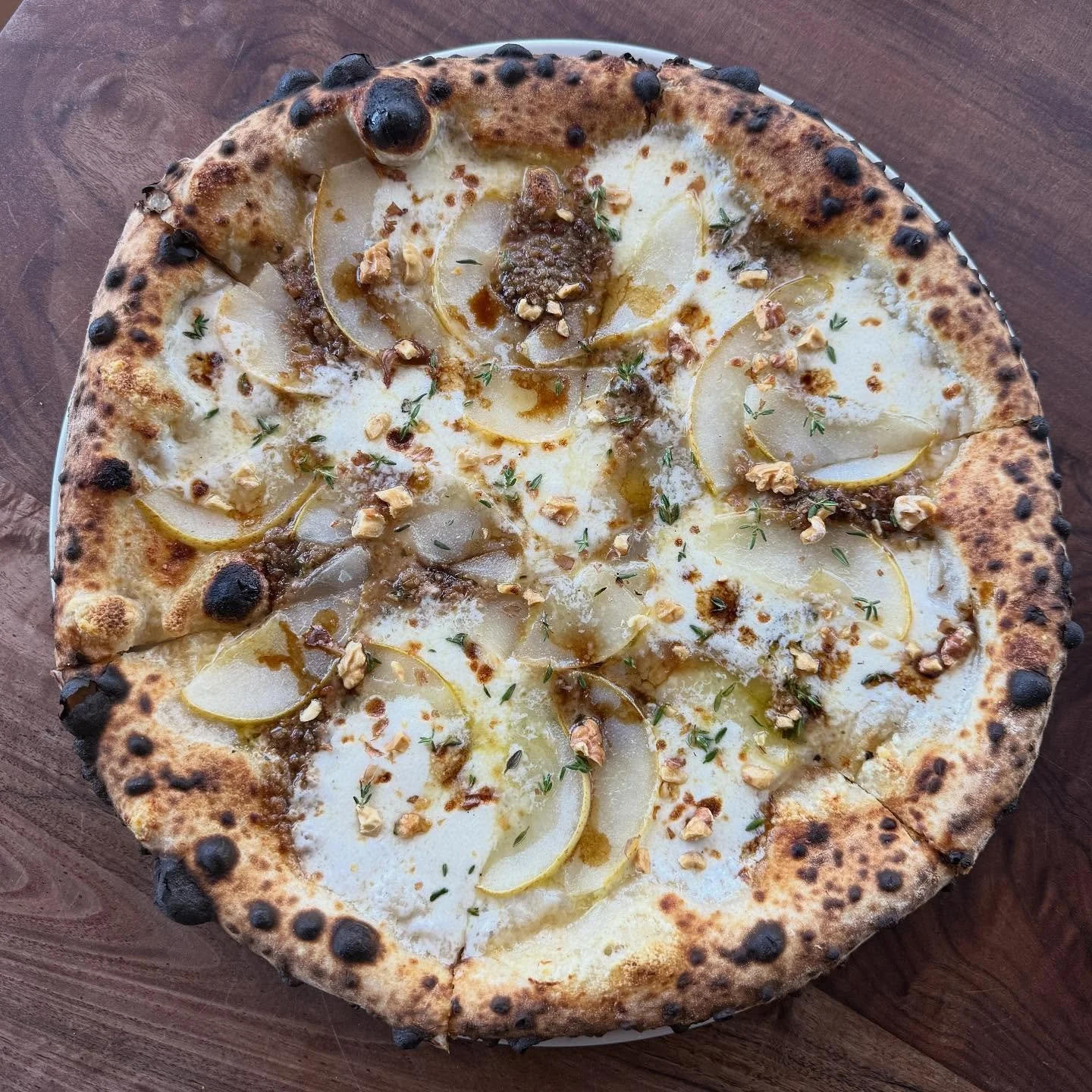 Sad to see peach pizza go but very excited for this @penrynorchardspecialties pear pizza by @oscar_desantiago_ &amp; @ed.uard.oo // She&rsquo;s featuring beautiful Bartlett pears, @springbrookfarmcheese reading raclette, an anchovy walnut pesto, red 