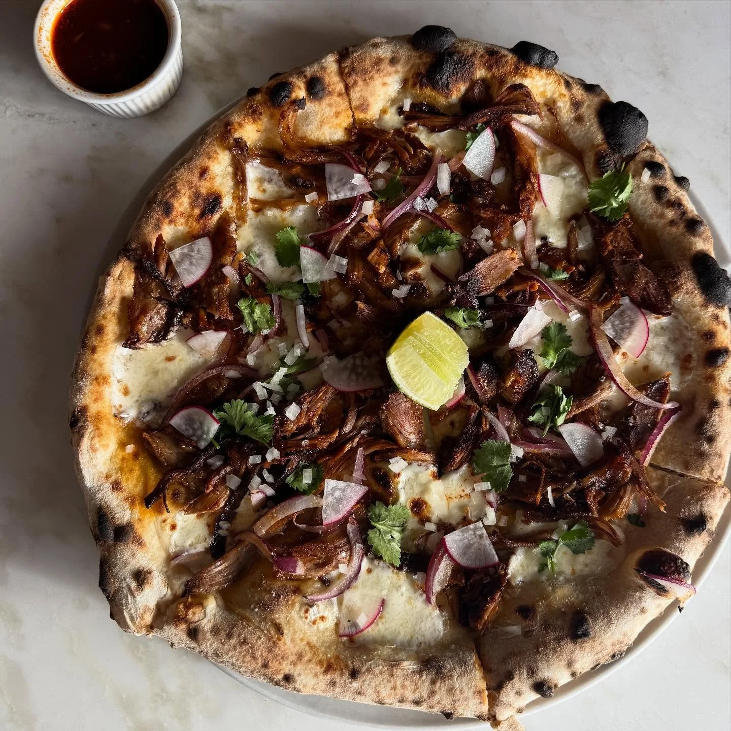 Goat birria pizza with a sidecar of consomm&eacute; by @oscar_desantiago_ // available for lunch today then we move into our next special pizza for tonight: Milliken sweet potato massaman curry! Goat pizza features @sbmeatco_porkpalace braised goat, 