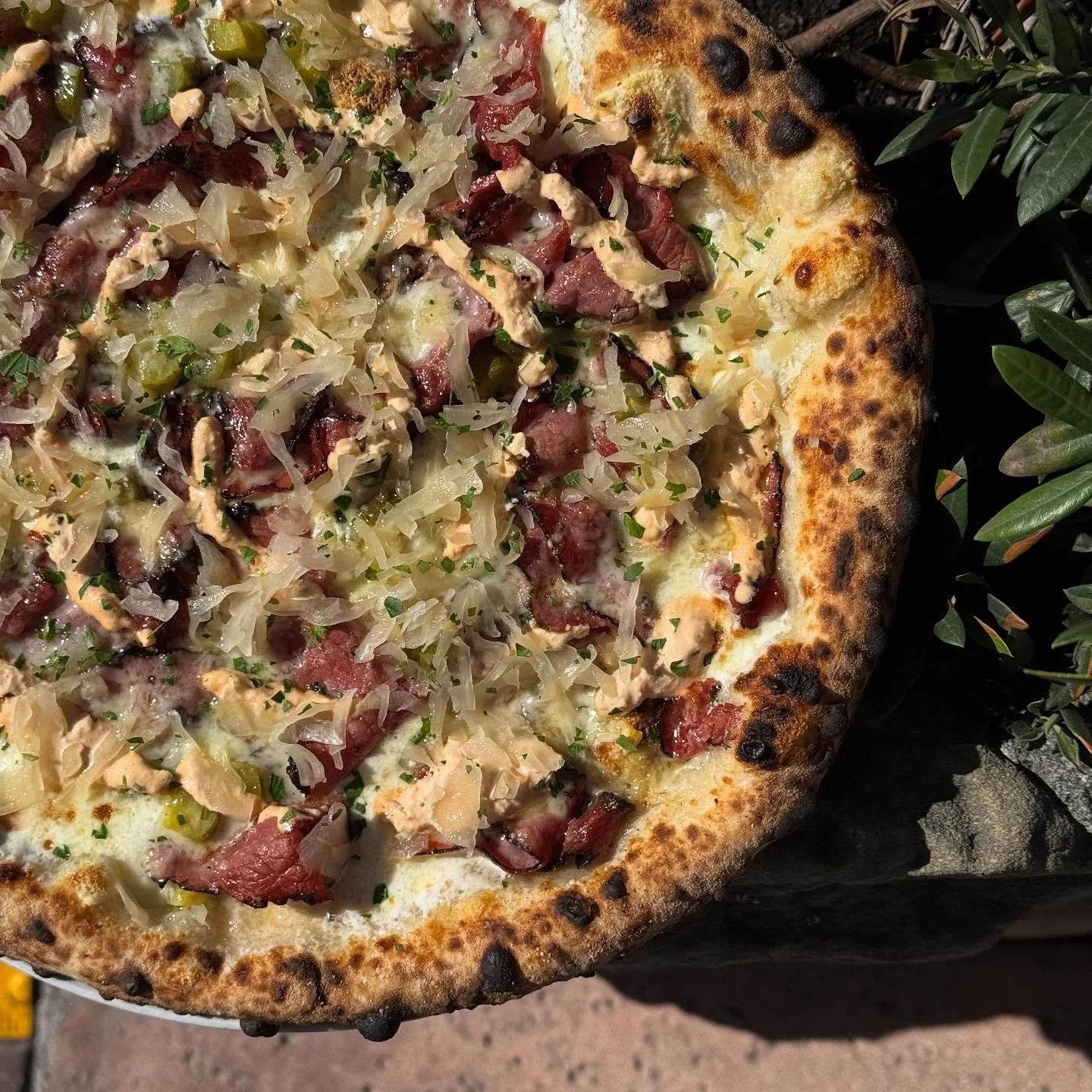 The pizza magic continues as we get closer to our anniversary tomorrow. We will be serving this insanely, good pastrami Reuben pizza by CDP @sadisticshark at lunch today. Raclette, New York style pastrami, pickled mustard seeds, sauerkraut, and Russi
