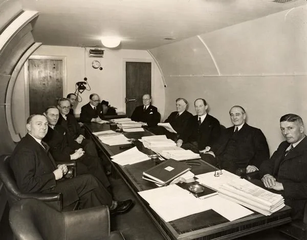 The Railway Executive Committee meets in an underground room in the disused Down Street station during the Second World War. Frank Pick, vice chairman of the London Transport Passenger Board Executive, is fourth from right. Down Street Underground st